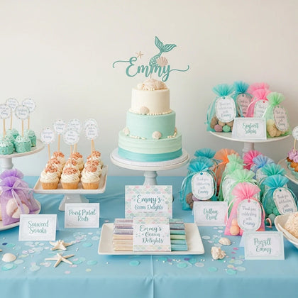 Mermaid birthday party dessert table with ocean cake seashell cupcakes and pastel favors