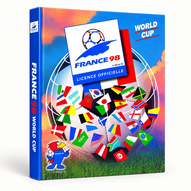 Official France 1998 World Cup licensed box set shown at a three-quarter angle against a plain white background. The box features the official tournament logo, a collage of international flags, a grassy field illustration, and the French footballer mascot, Coeur de Lion, on the front and spine.