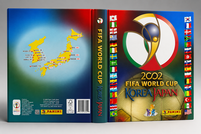 Panini FIFA World Cup Korea Japan 2002 collectible card box set shown in a three-dimensional cover view. The packaging features a vibrant blue and red design with a yellow map of Japan on the back, the official tournament emblem, and columns of national flags on the side.