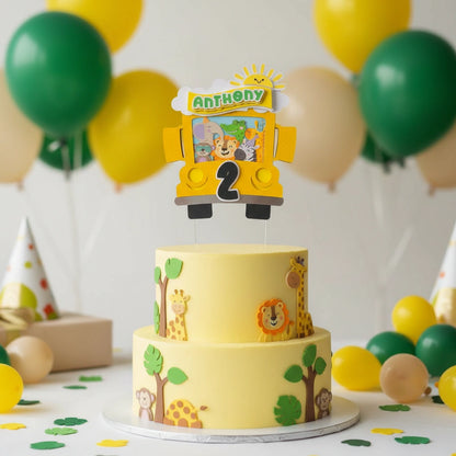 Two-tier birthday cake with animal-themed decorations and a 'Anthony' topper, surrounded by balloons.