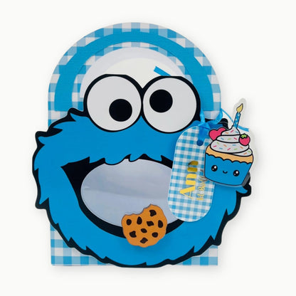 Cookie Monster background holding a cupcake with a candle.