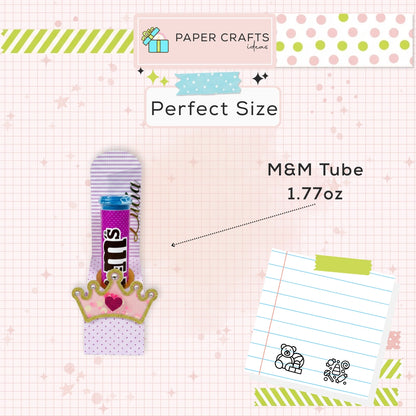 M&M tube with a crown design on a checkered background with stationery items.