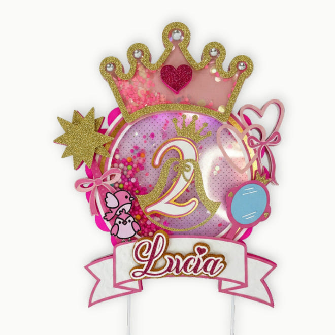 Decorative birthday cake topper with number 2, princess crown, and name Lucia on a white background.